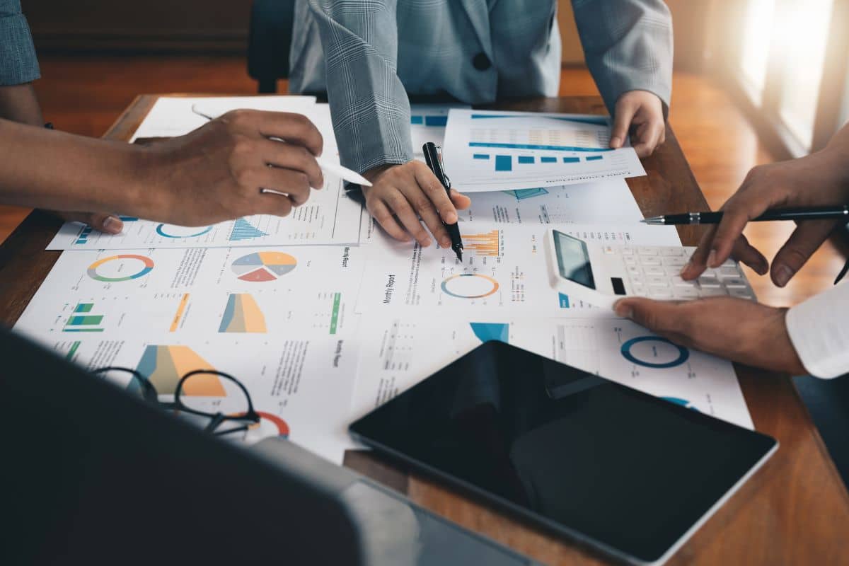 Lending team reviewing growth reports